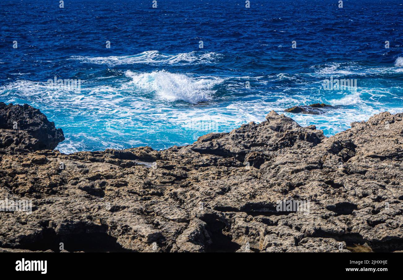 A view of sea waves breaking rocky beach Stock Photo - Alamy