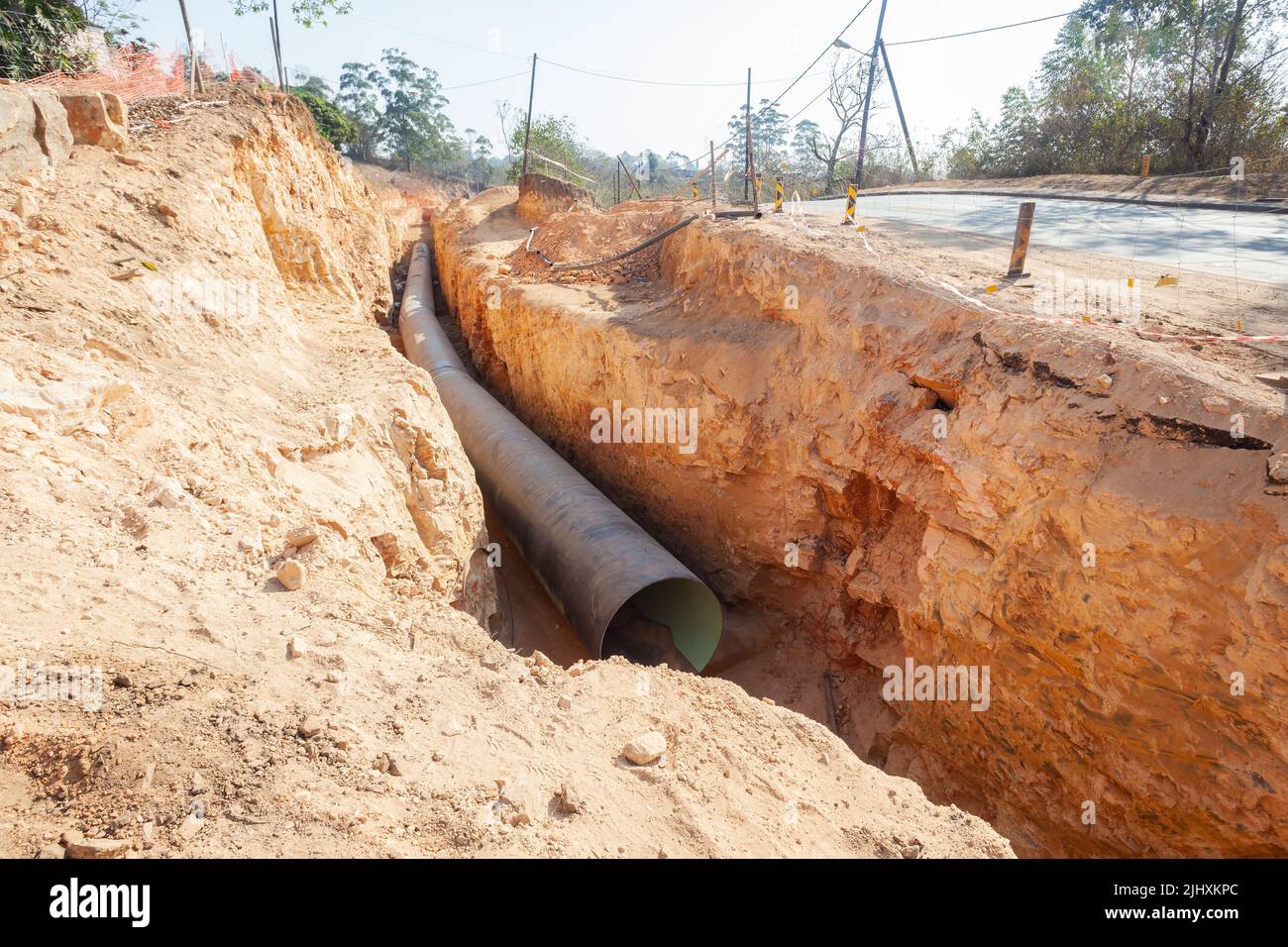 New aquaduct waterline construction of large steel water pipes in deep earth trench installed