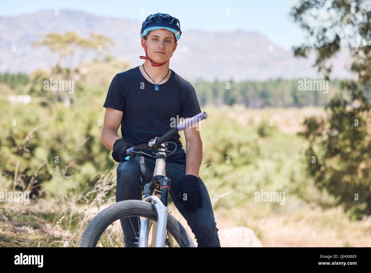 Portrait of a handsome man wearing a helmet while cycling on his