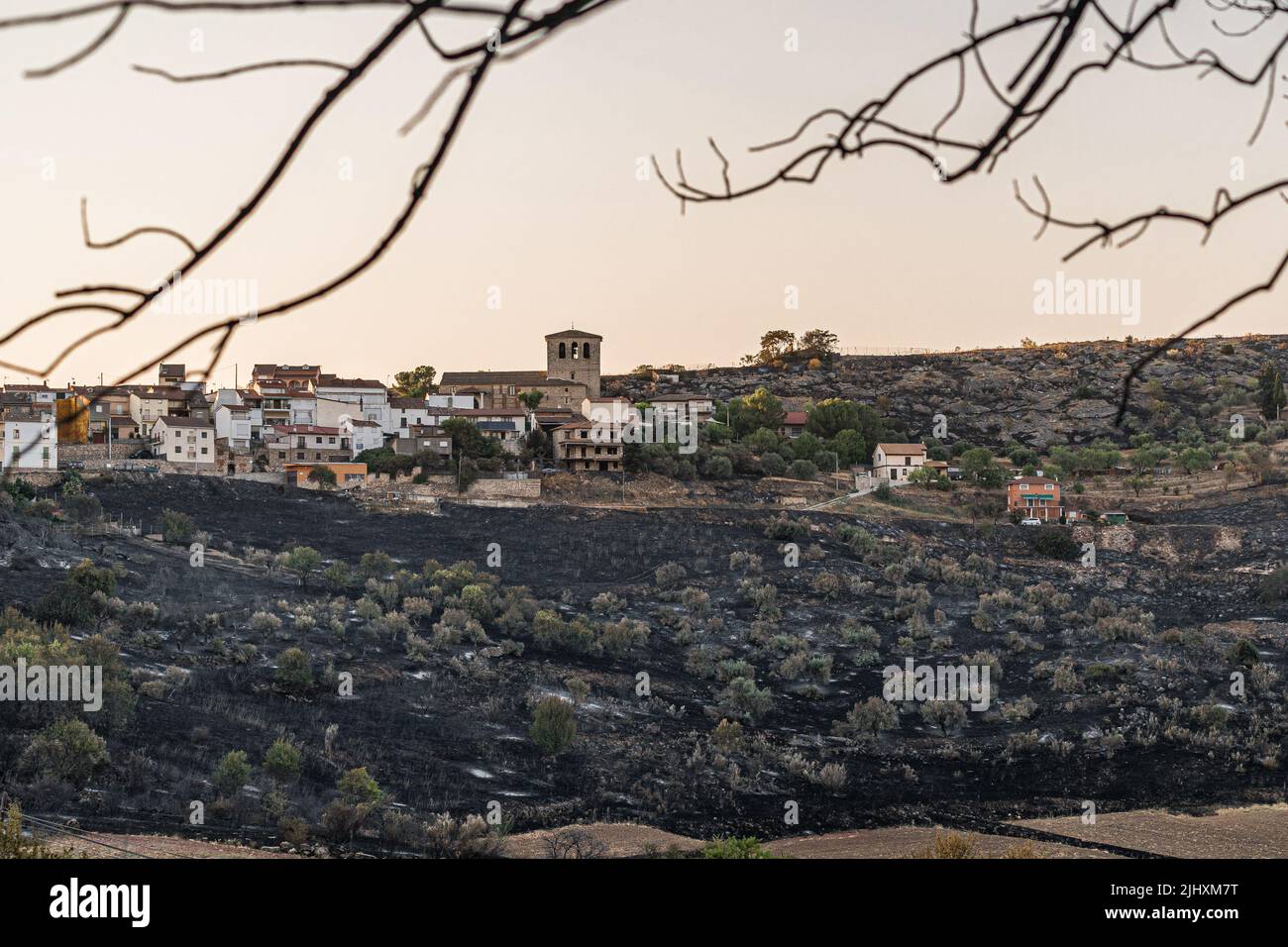 The slopes of Valdepeñas de la Sierra devastated by the flames of the fire. The fire did not affect the buildings. The Red Cross shelter in the town of Uceda, next to Valdepeñas de la Sierra, welcomed more than 150 people from the towns affected by the fire. The forest fire that lasted more than 48 hours in Valdepeñas de la Sierra, 80 kilometers from Madrid, Spain, destroyed more than 3,000 hectares. The authorities suspect that the fire could have been caused by a pyromaniac during the days of high heat temperatures recorded in Spain. Stock Photo