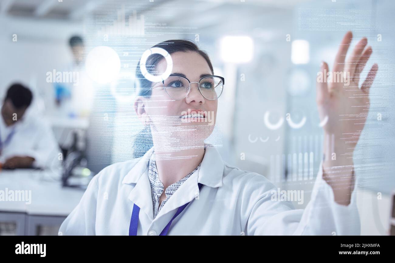 Checked into the future. a young female lab technician using an interactive board. Stock Photo