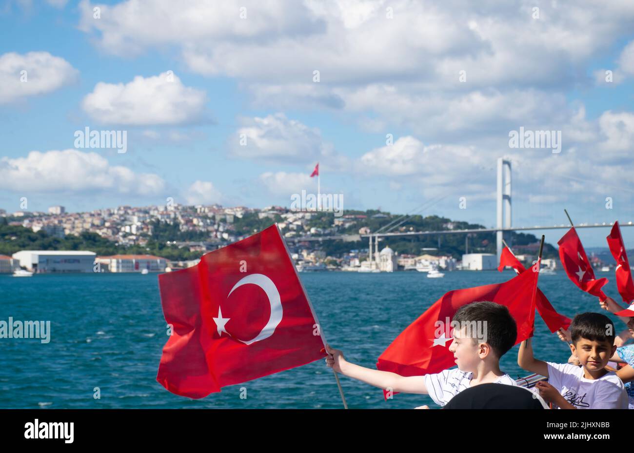 Istanbul, Turkey - July 2022: Children waving Turkish flag. A group of children waving the Turkish flag on a ship. Stock Photo