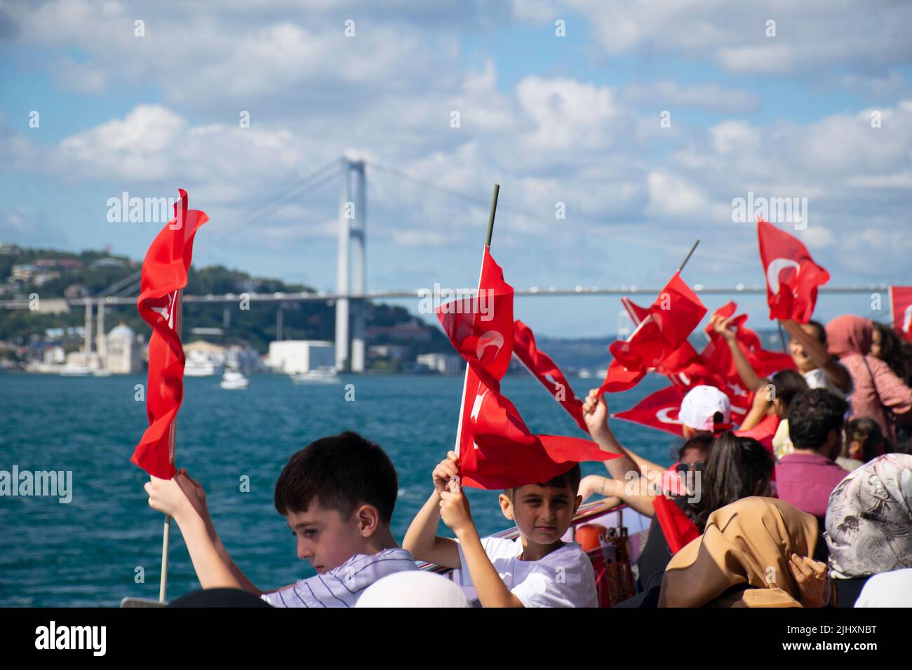 Istanbul, Turkey - July 2022: Children waving Turkish flag. A group of children waving the Turkish flag on a ship. Stock Photo