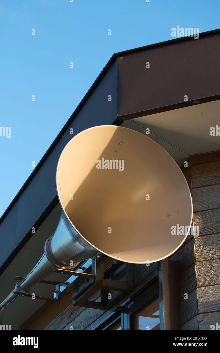 large beige loudspeaker on the side of a building Stock Photo
