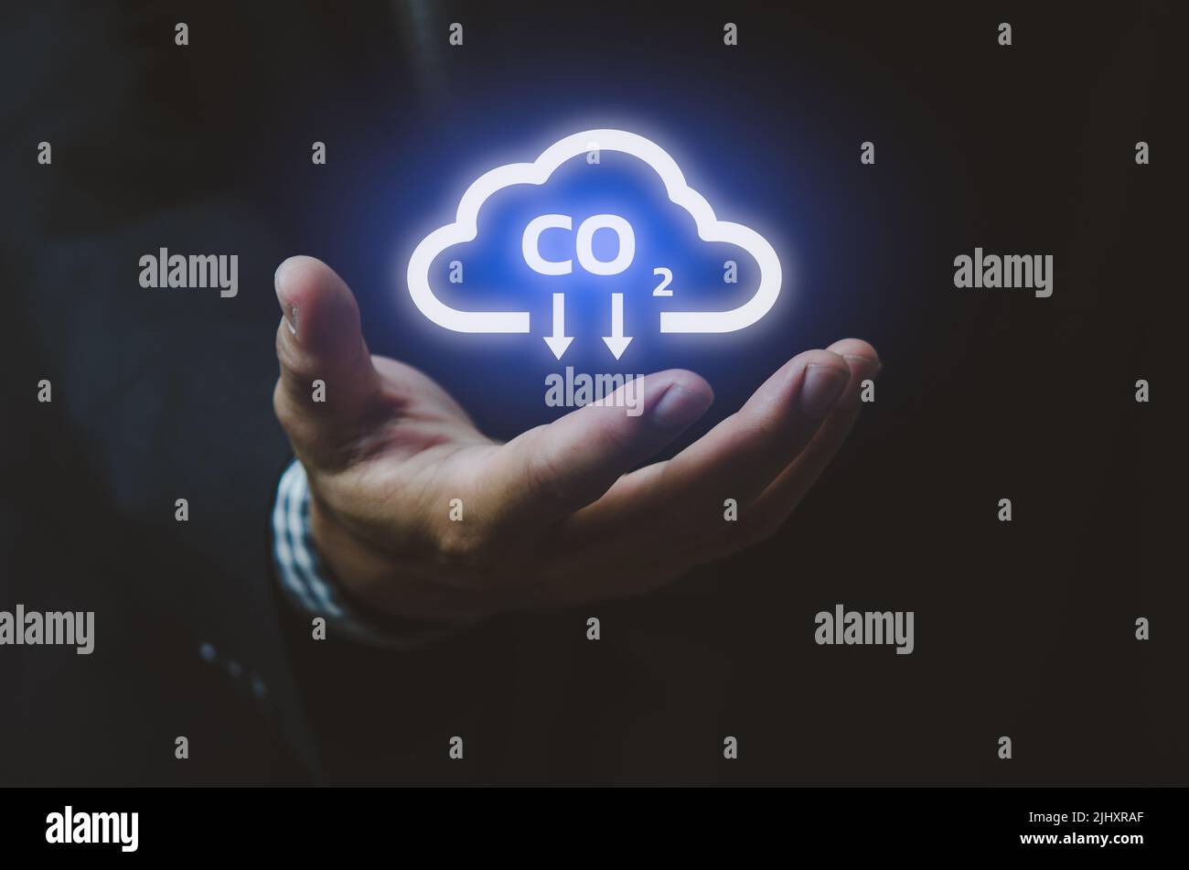 Man hand icon cloud. Sustainable eco energy CO2 emissions and global warming with investment constraints  icons and symbols virtual screen. Business c Stock Photo