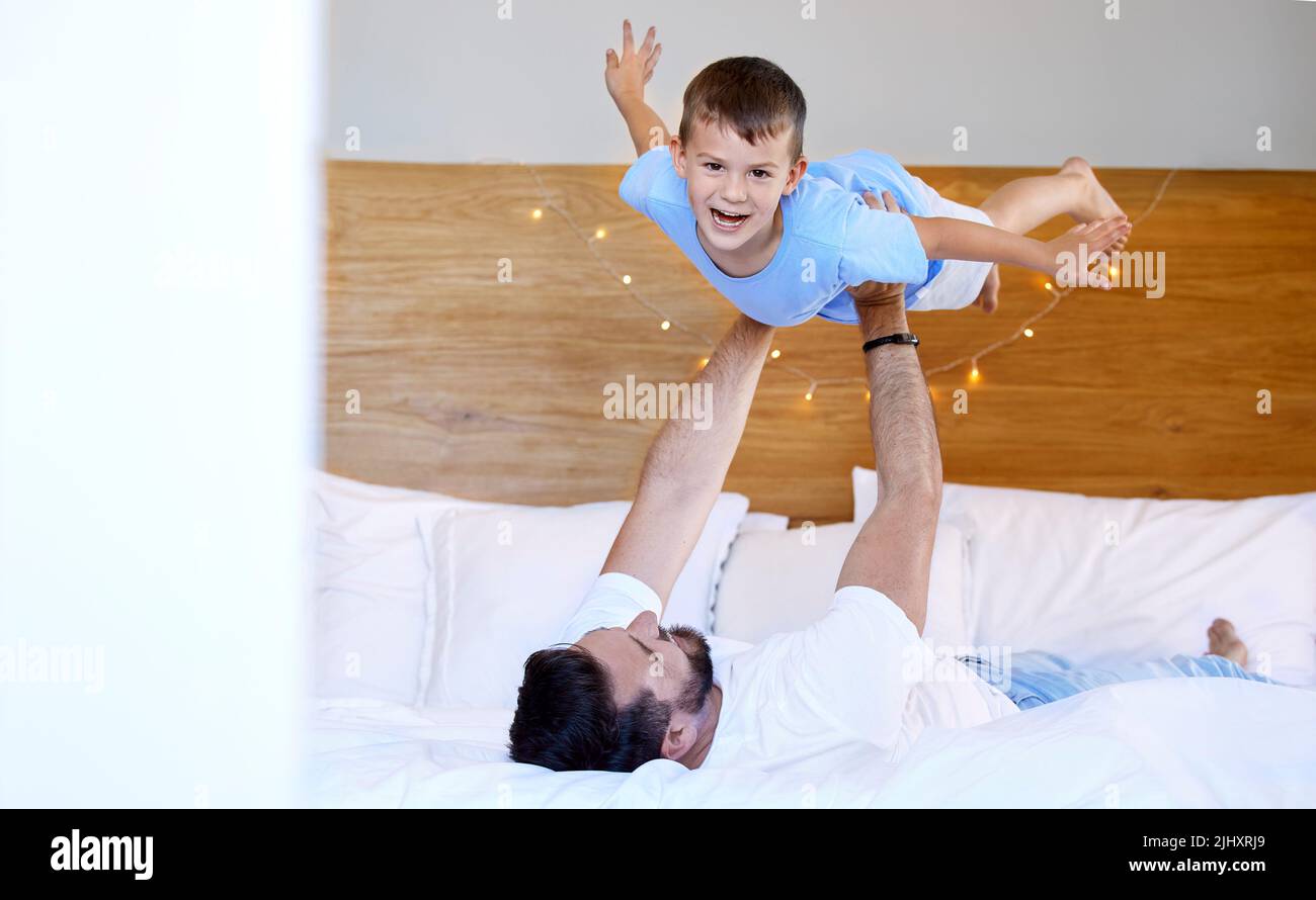 Father and son pretending to fly hires stock photography and images
