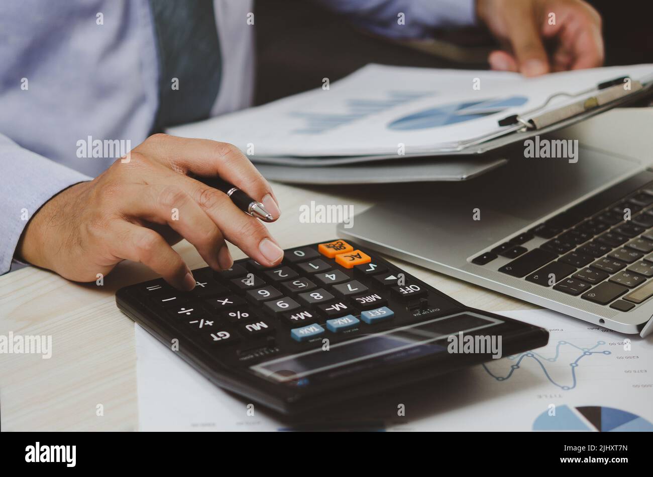 Businessman Holding Calculators And Business Documents Charts Businessman Holding Calculators And Business Documents Charts