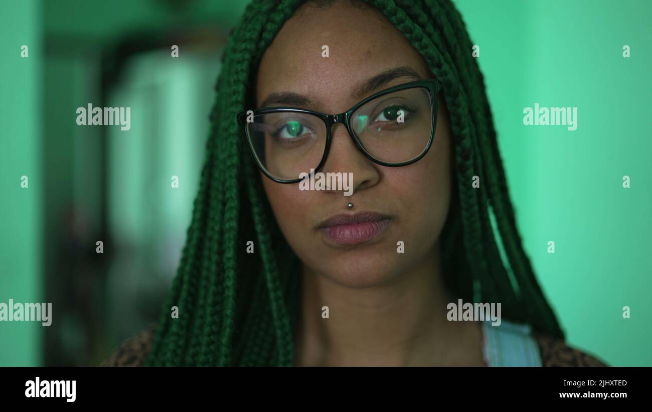 One young serious black woman with box braids hairstyle portrait face