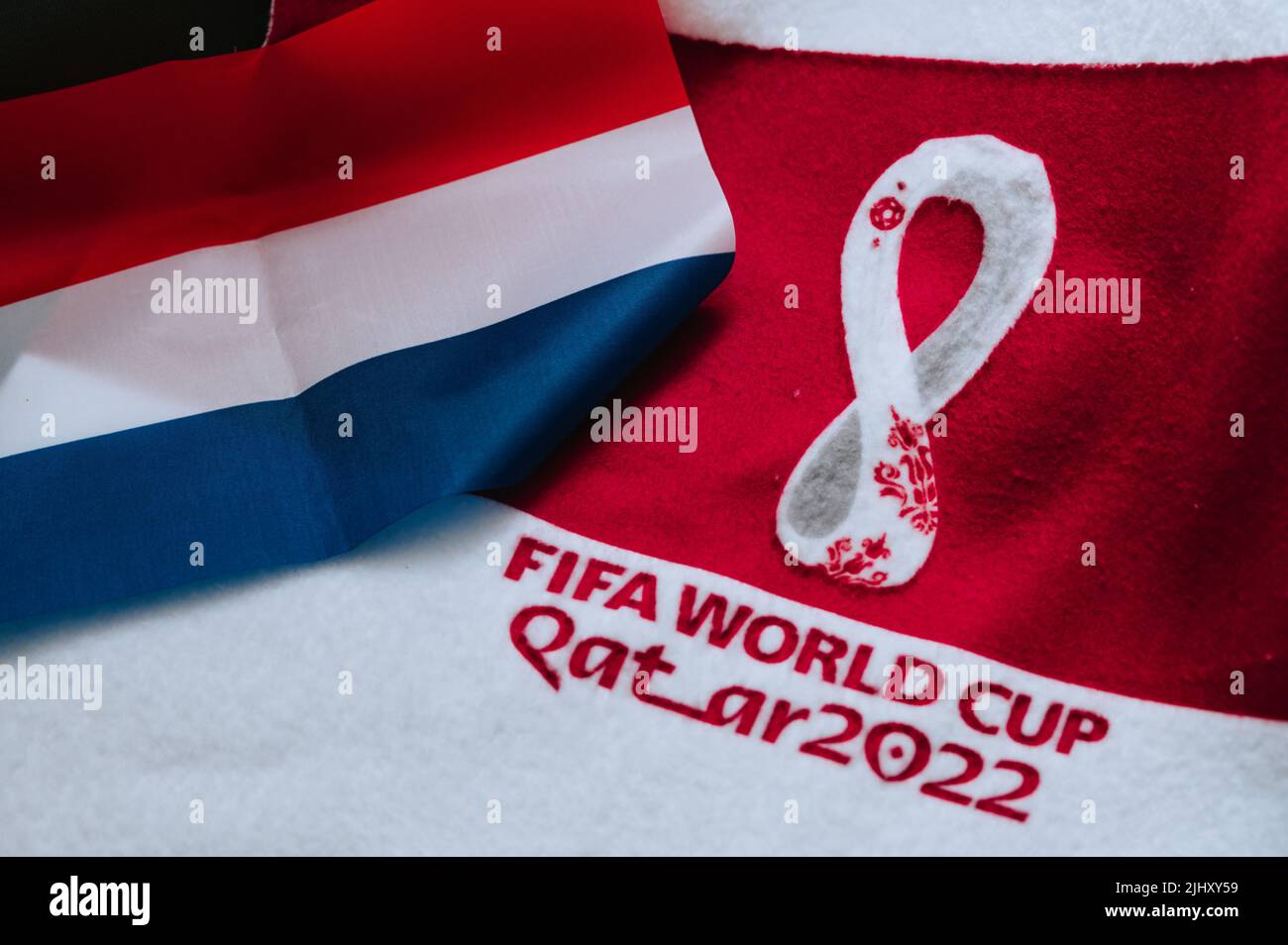 QATAR, DOHA, 18 JULY, 2022: Netherlands National flag and logo of FIFA World Cup in Qatar 2022 on red carpet. Soccer sport background, edit space. Qat Stock Photo