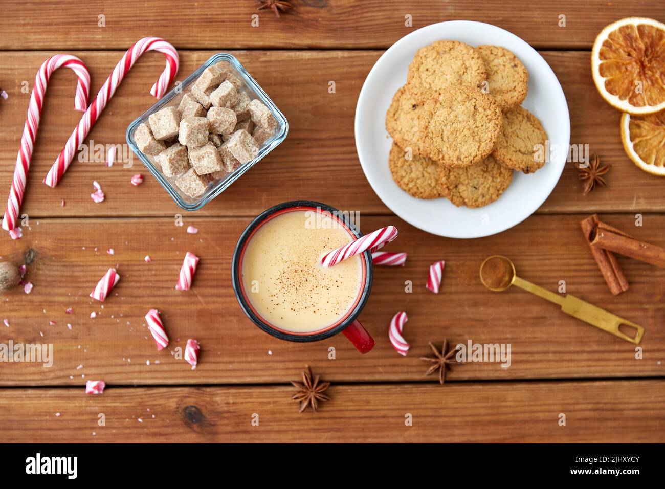 cup of eggnog with candy cane, cookies and sugar Stock Photo Alamy