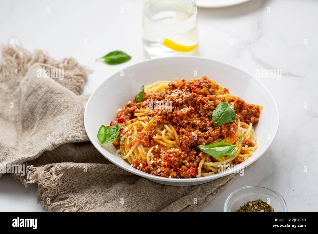 Close up of bolognese pasta in white bowl italian food Stock Photo