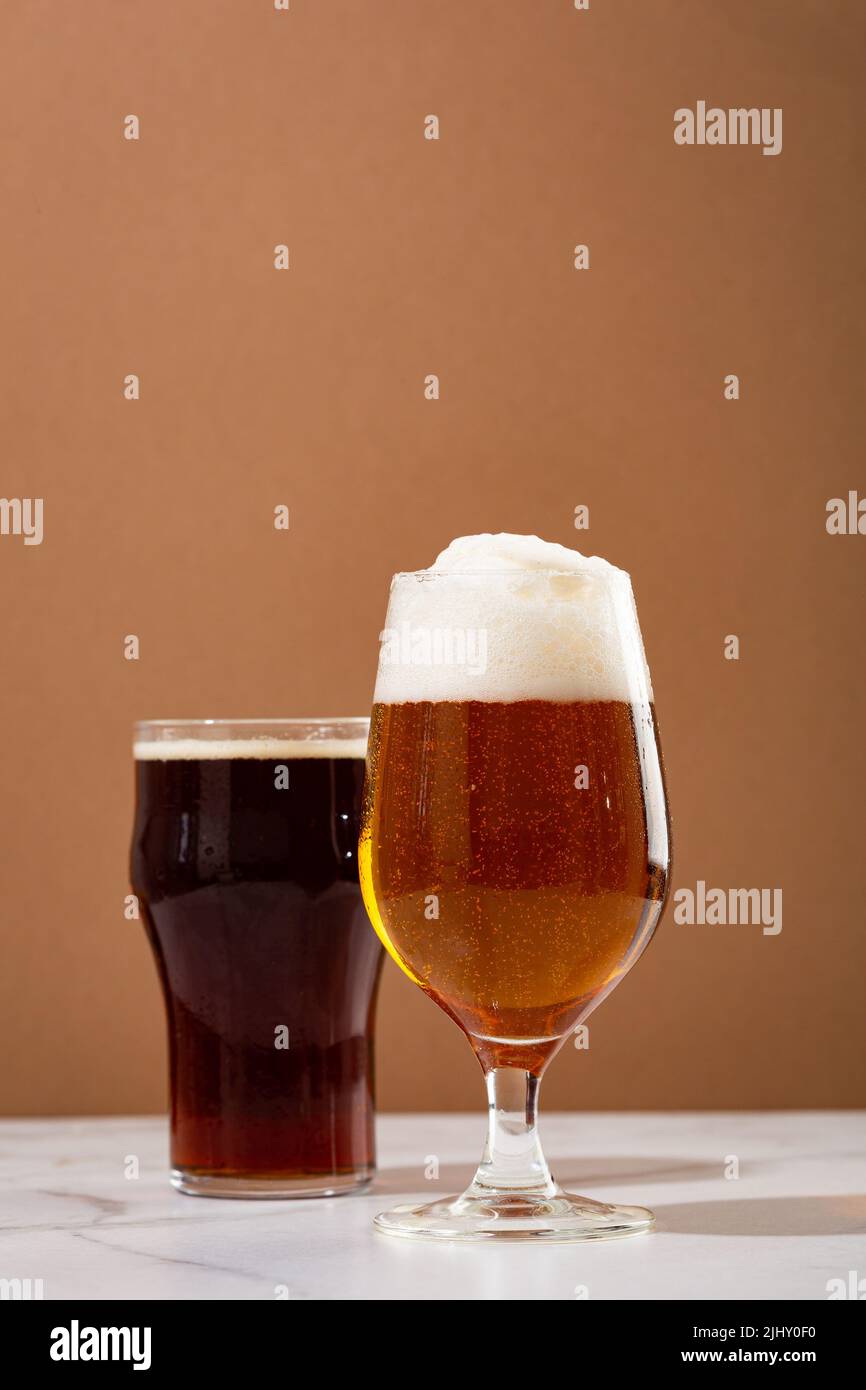 Two glasses with light and dark beer beverages Stock Photo Alamy
