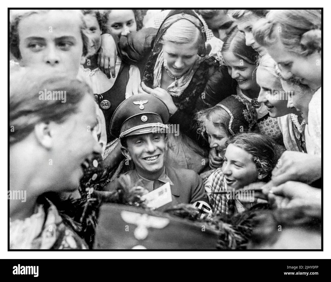Nazi leader Joseph Goebbels surrounded by enthusiastic League of German Girls or the Band of German Maidens (German: Bund Deutscher Mädel, abbreviated as BDM)  the girls' wing of the Nazi Party youth movement, the Hitler Youth. Paul Joseph Goebbels, (born October 29, 1897, Rheydt, Germany—died May 1, 1945, Berlin), minister of propaganda for the German Third Reich under Adolf Hitler. A master orator and propagandist, he presented a favourable image of the Nazi regime to the German people. Adolf Hitler created the Reich Ministry of Public Enlightenment & Propaganda with Goebbels at its head. Stock Photo