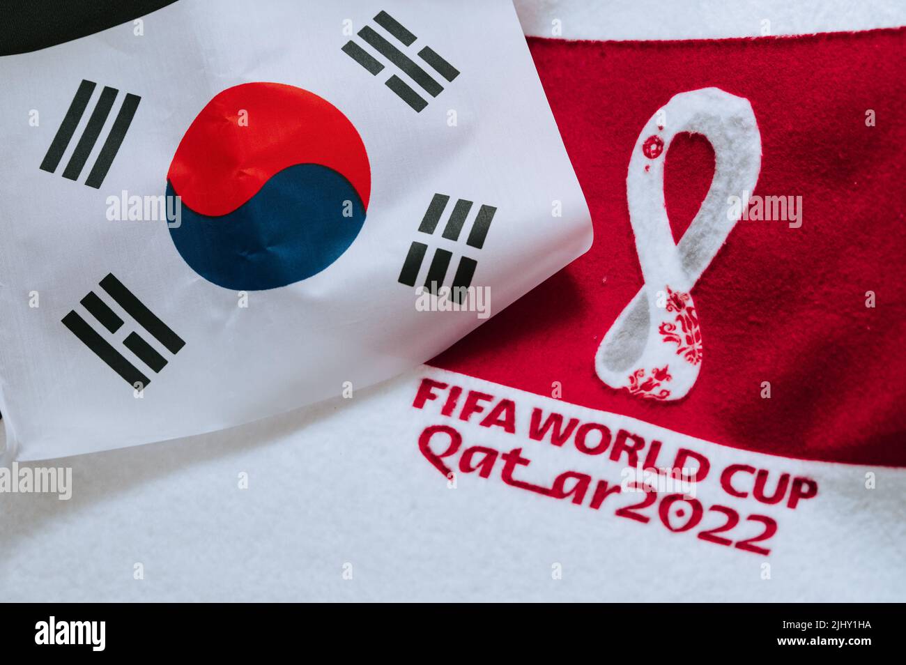 QATAR, DOHA, 18 JULY, 2022: South Korea National flag and logo of FIFA World Cup in Qatar 2022 on red carpet. Soccer sport background, edit space. Qat Stock Photo