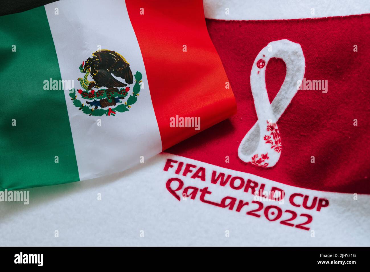 QATAR, DOHA, 18 JULY, 2022: Mexico National flag and logo of FIFA World Cup in Qatar 2022 on red carpet. Soccer sport background, edit space. Qatar 22 Stock Photo