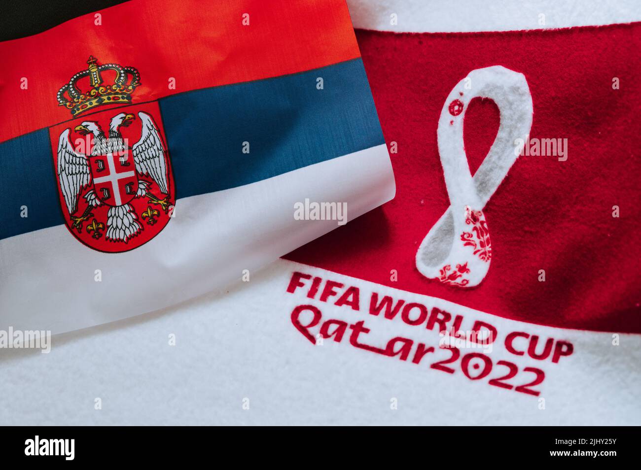 QATAR, DOHA, 18 JULY, 2022: Serbia National flag and logo of FIFA World Cup in Qatar 2022 on red carpet. Soccer sport background, edit space. Qatar 22 Stock Photo