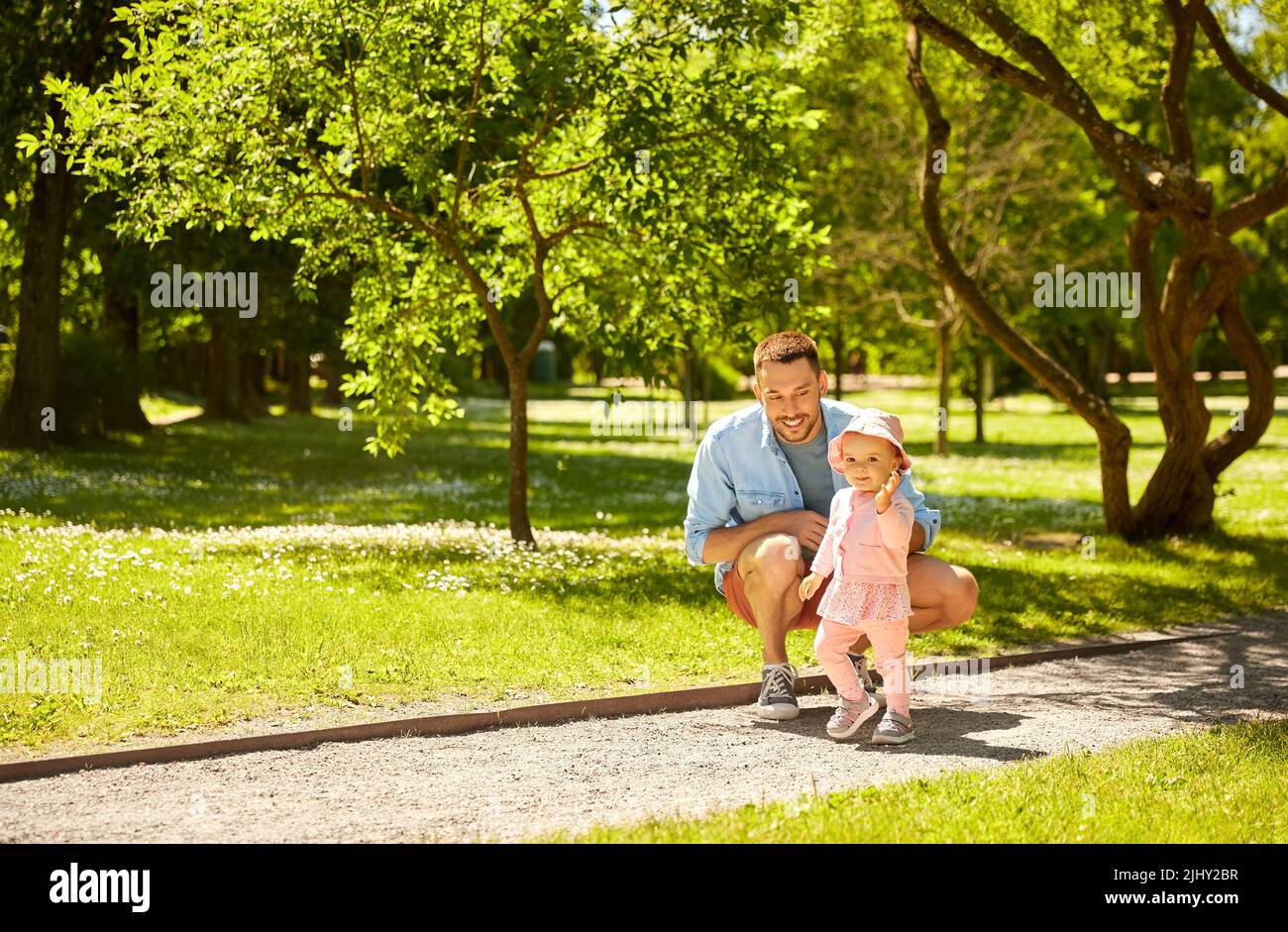 happy father with baby daughter at summer park Stock Photo - Alamy