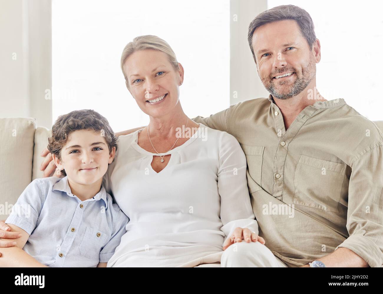 Happy with our little family. a young couple bonding with their son on the sofa at home. Stock Photo