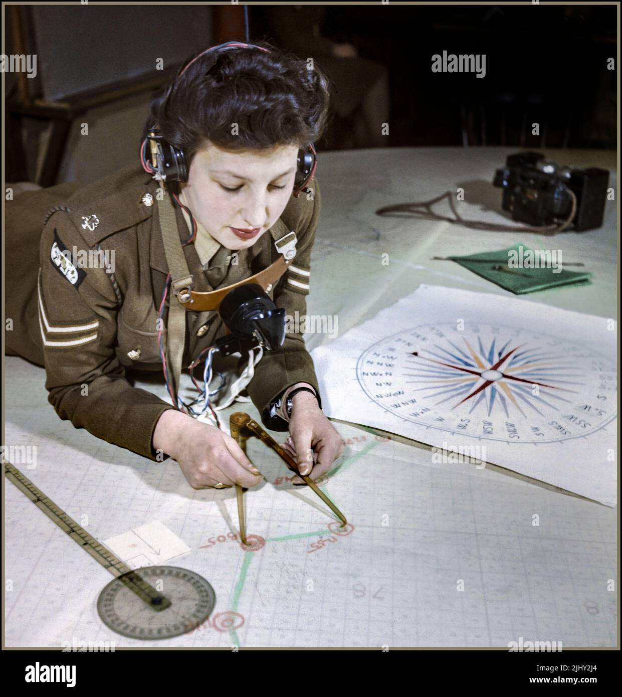 WW2 COASTAL DEFENCE GUNNERY OPERATIONS PROPAGANDA IMAGE Women’s Auxiliary Territorial Service, Miss Elizabeth Amery, computes the range at 428 Battery, Coastal Defence Artillery Headquarters, Dover, December 1942.  World War II WW2 Date 1942 Stock Photo