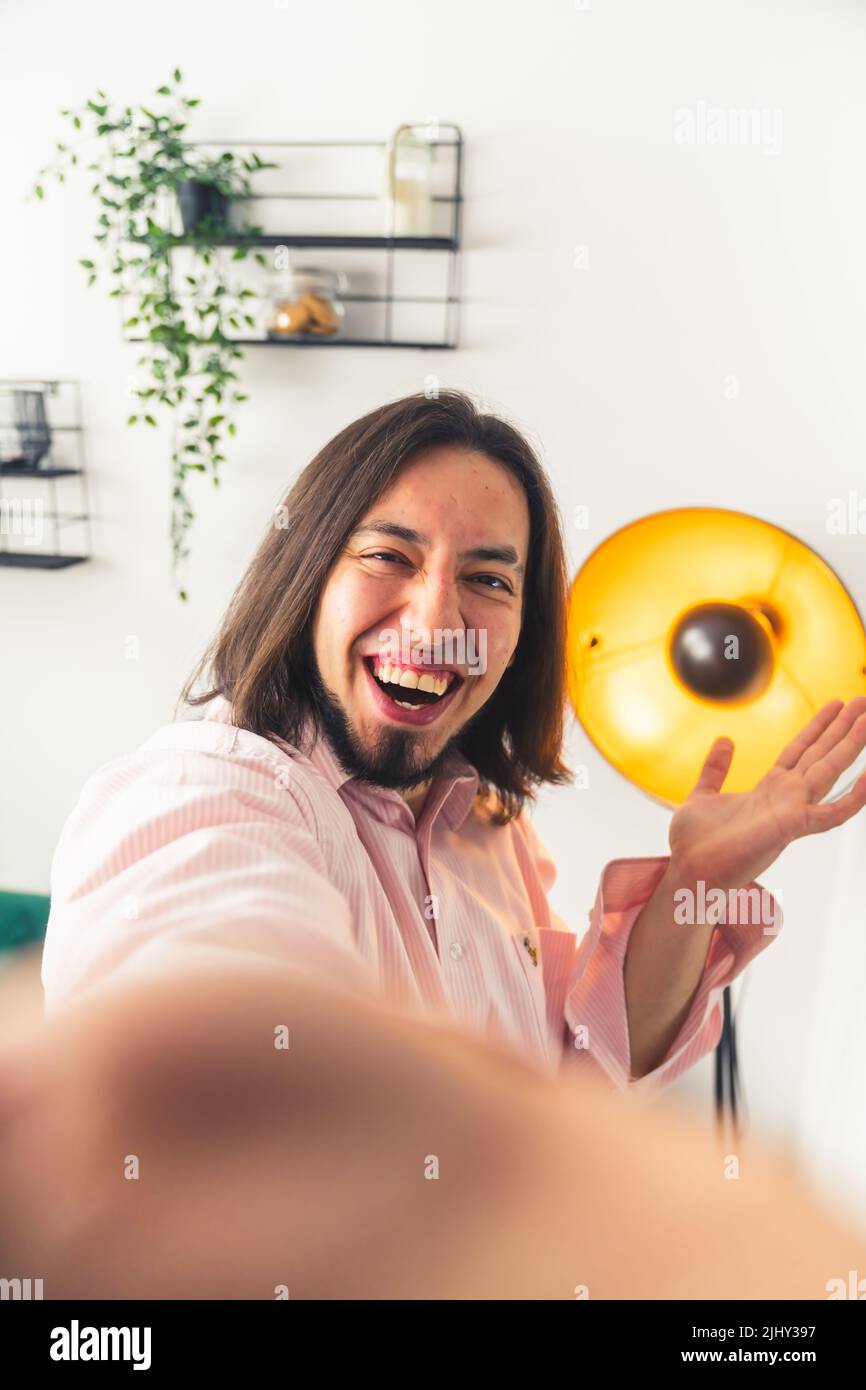 A happy adult person who is smiling and looking in the lens of camera in the room - hold by hand. High quality photo Stock Photo