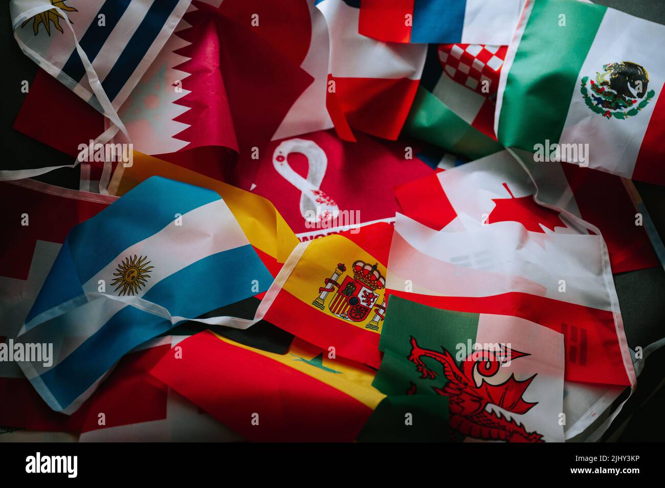 QATAR, DOHA, 18 JULY, 2022: Flags of all participants of FIFA World Cup in Qatar 2022. Logo of World Cup in the Middle. Football Tournament Background Stock Photo