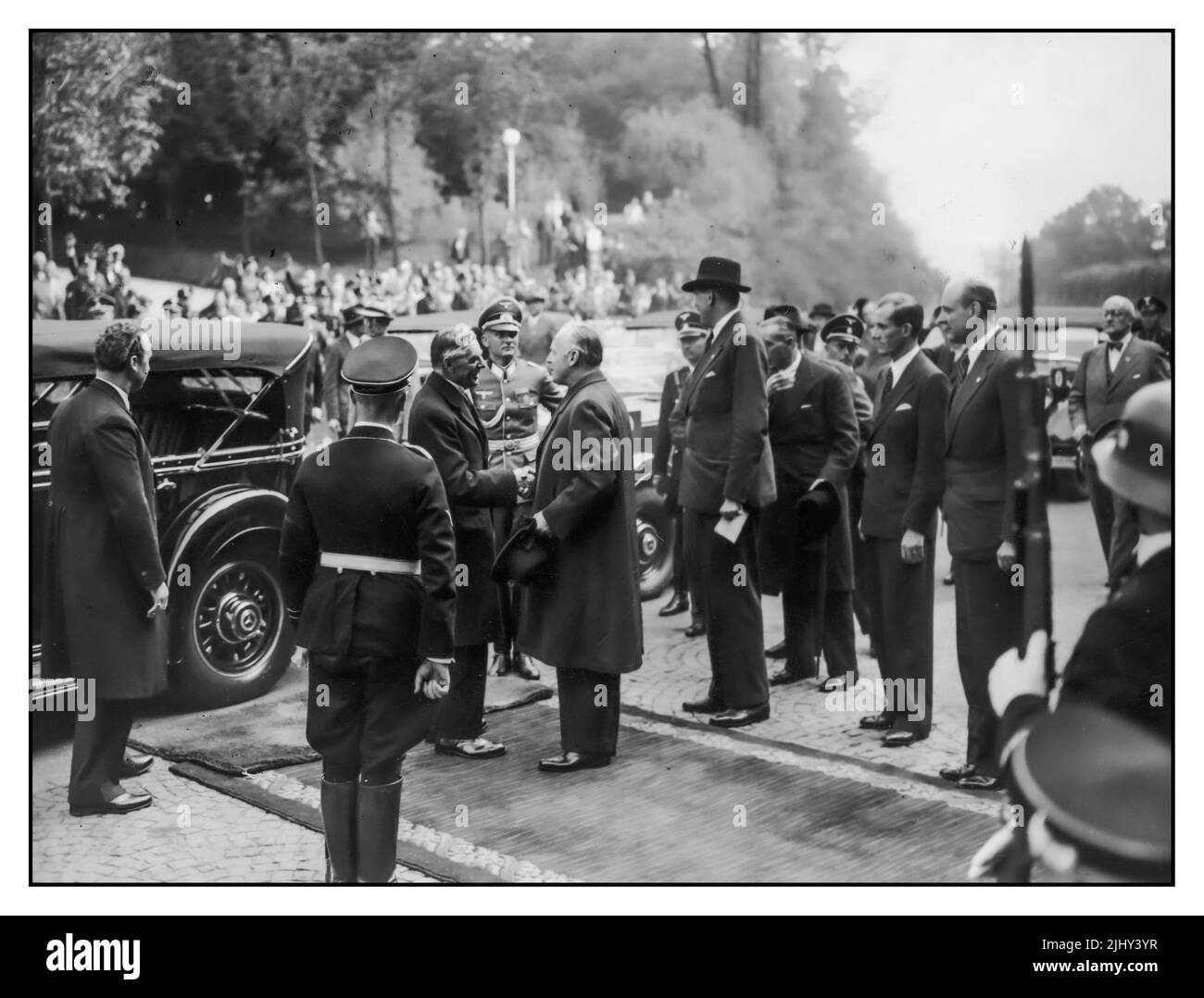 1938 Munich Agreement Appeasement . Arrival of Neville Chamberlain. Chamberlain (British Prime Minister), Joachim von Ribbentrop (Minister of Foreign Affairs of Nazi Germany from 1938 to 1945), Alexander von Dörnberg (head of the Protocol Department of the German Foreign Office) etc. in Münich on September 29th. 1938. 'Peace in our Time' Stock Photo