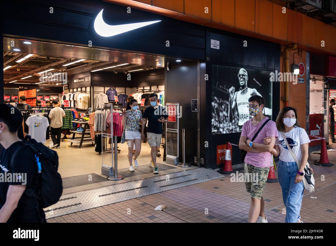 Hong Kong, China. 18th July, 2022. Shoppers walk past the American  multinational sports clothing brand Nike