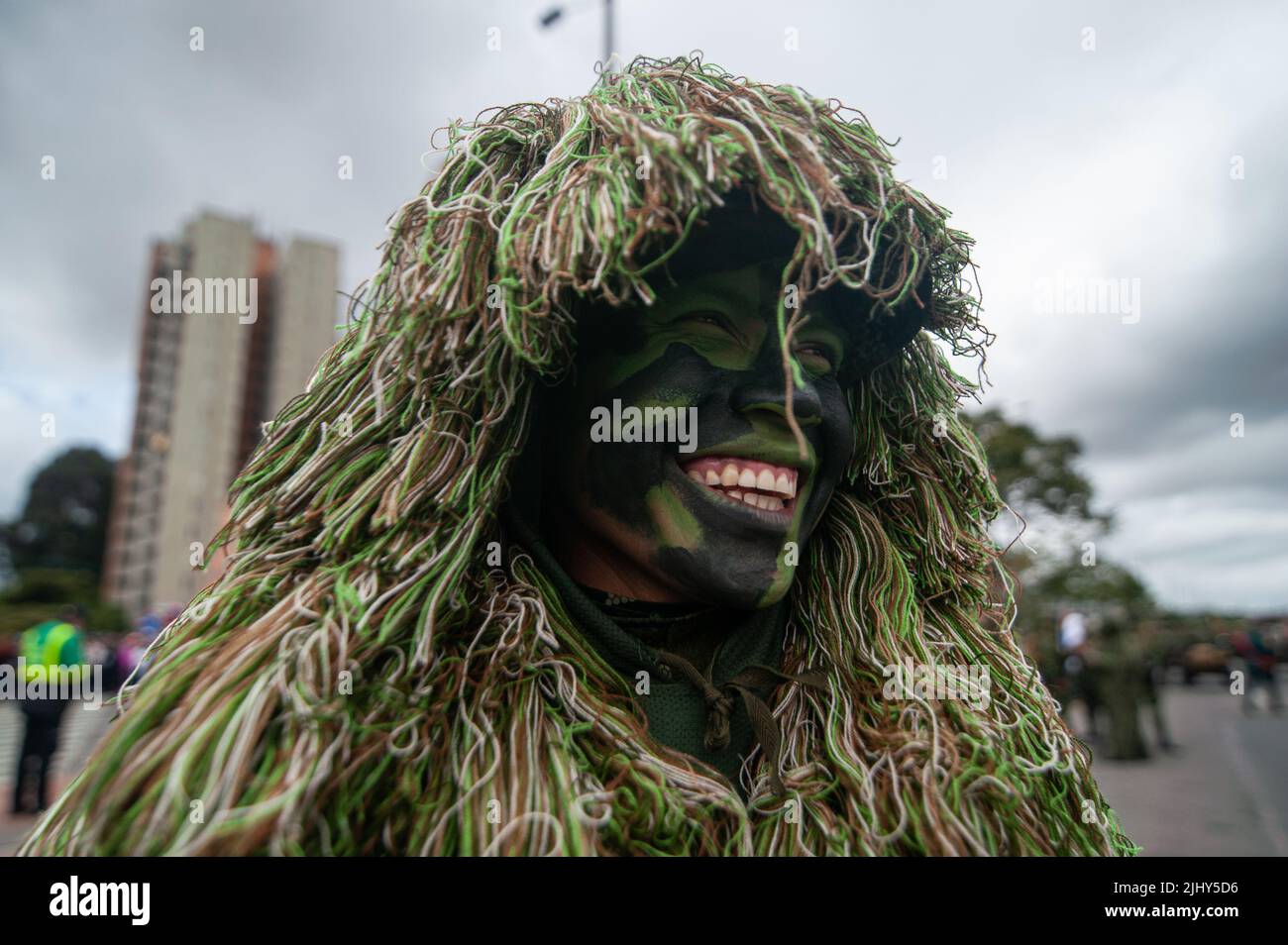 A Colombian army sniper smile while posing for a photo with his camouflage suit and face paint during the 212 years of independence of Colombia milita Stock Photo