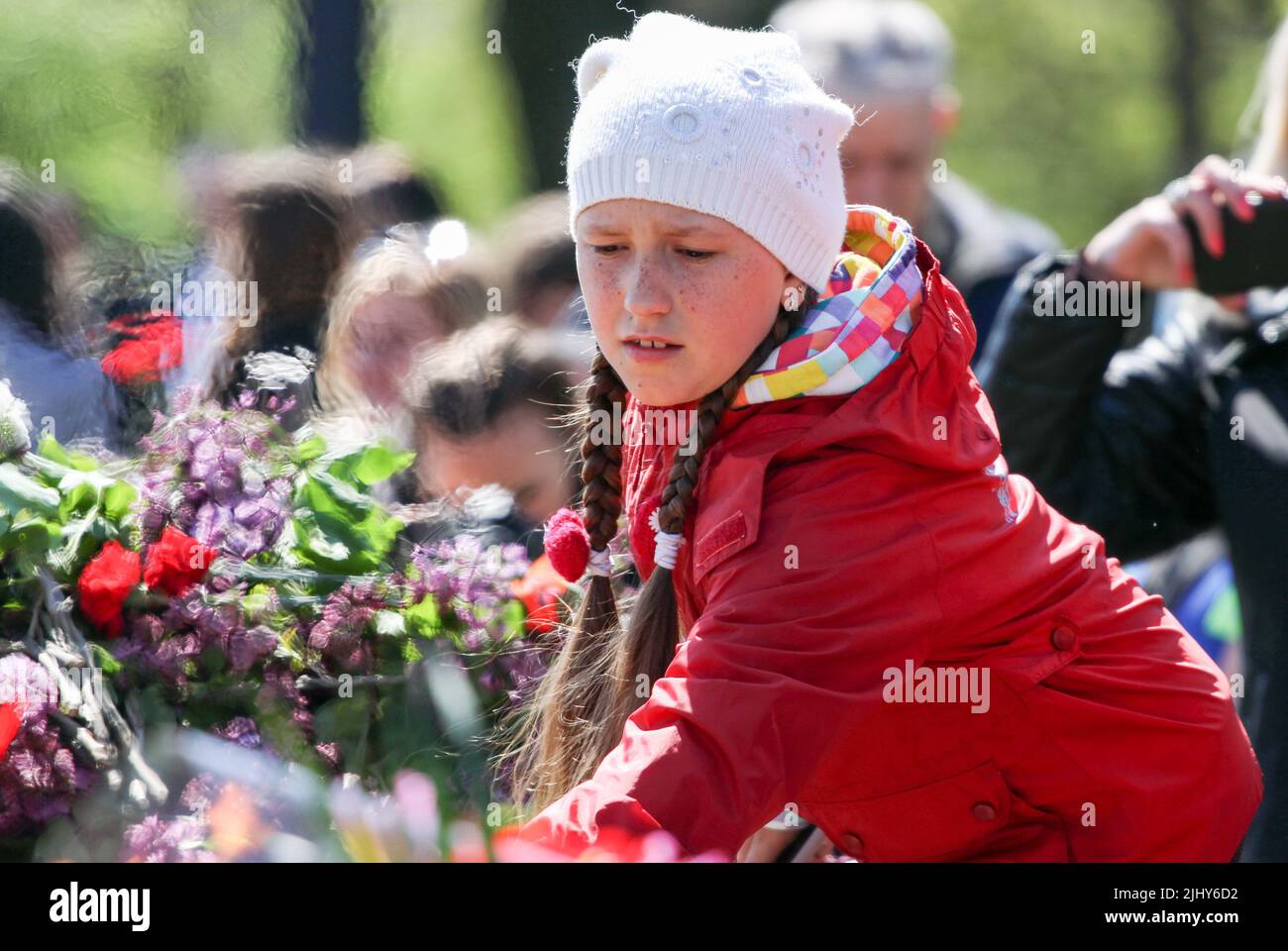 A child seen laying flowers during the event. On May 9, 2021, Ukraine ...