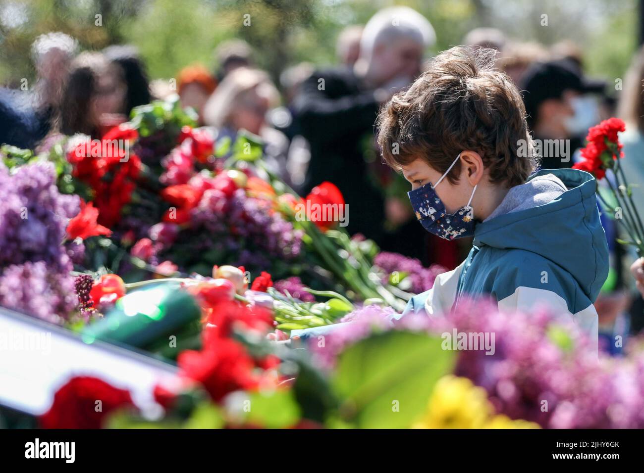 A child seen laying flowers during the event. On May 9, 2021, Ukraine ...