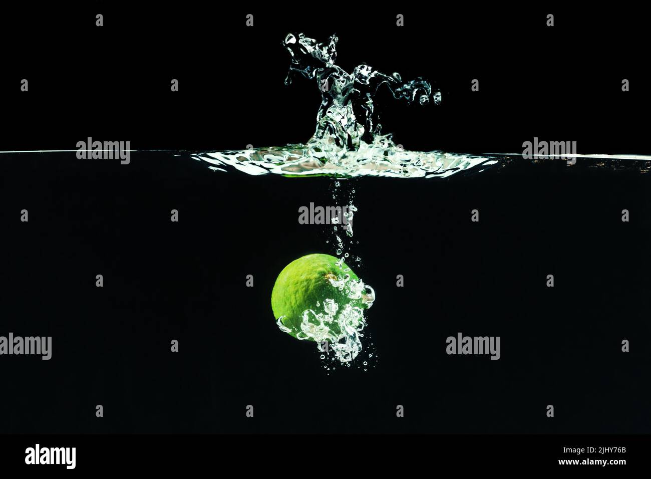 Fresh lime dropped into water with splash Stock Photo Alamy