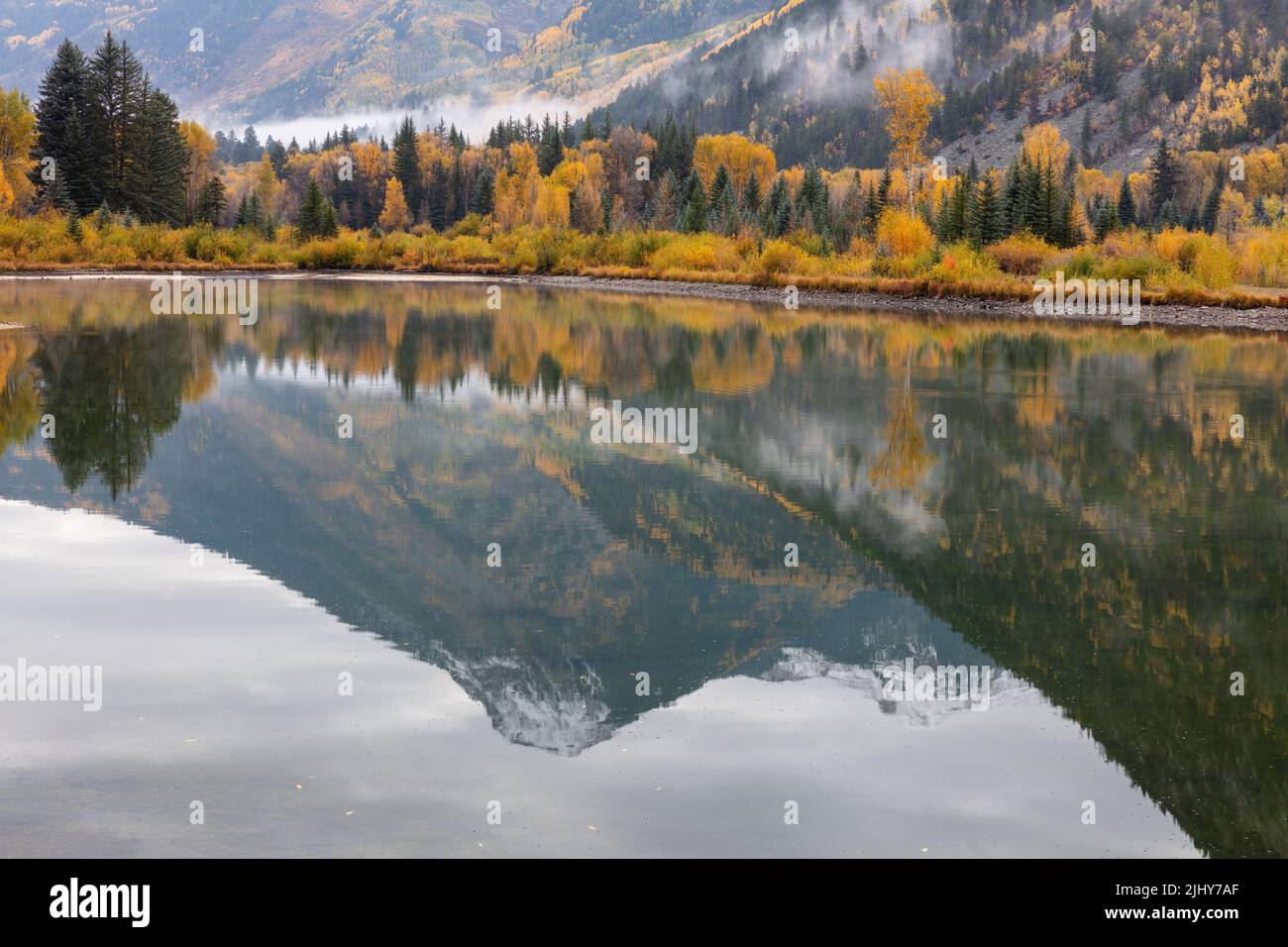 Aspen and snow-capped mountain reflected in a pond near Marble, White River National Forest, Colorado Stock Photo