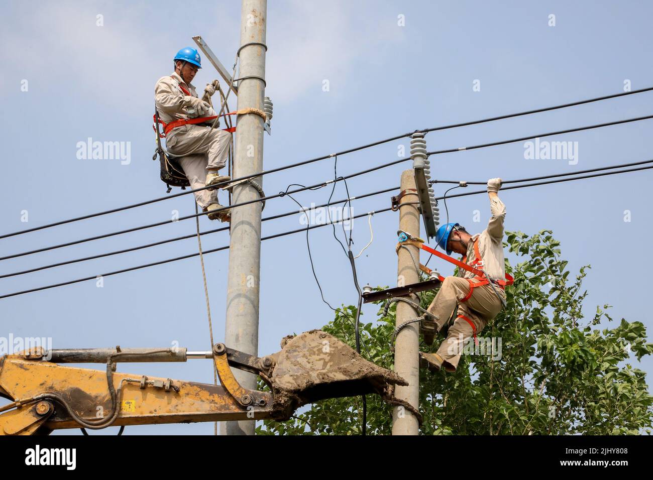 (220721) -- NANJING, July 21, 2022 (Xinhua) -- Electricians check power facilities after a tornado hit in Huating Village of Xiaoyi Township in Guanyun County, east China's Jiangsu Province, July 21, 2022. A tornado struck Lianyungang City in east China's Jiangsu Province on Wednesday, resulting in one fatality and 25 injured, local emergency management bureau said Thursday. The tornado swept through 11 villages in four townships of Lianyungang at around 12 p.m. on Wednesday. Emergency workers were quick to arrive at the scene and the injured are currently being treated. Relief work is a Stock Photo