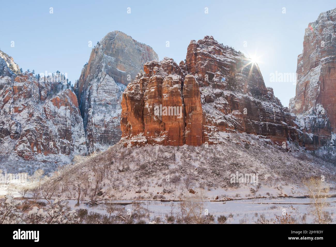 Sunburst behind Angels Landing in winter, Zion National Park, Utah Stock Photo