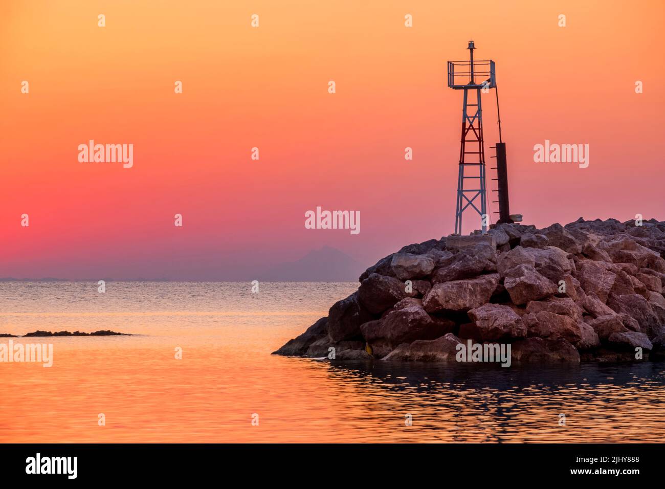 Sunrise seascape of a lighthouse at the foreground Stock Photo