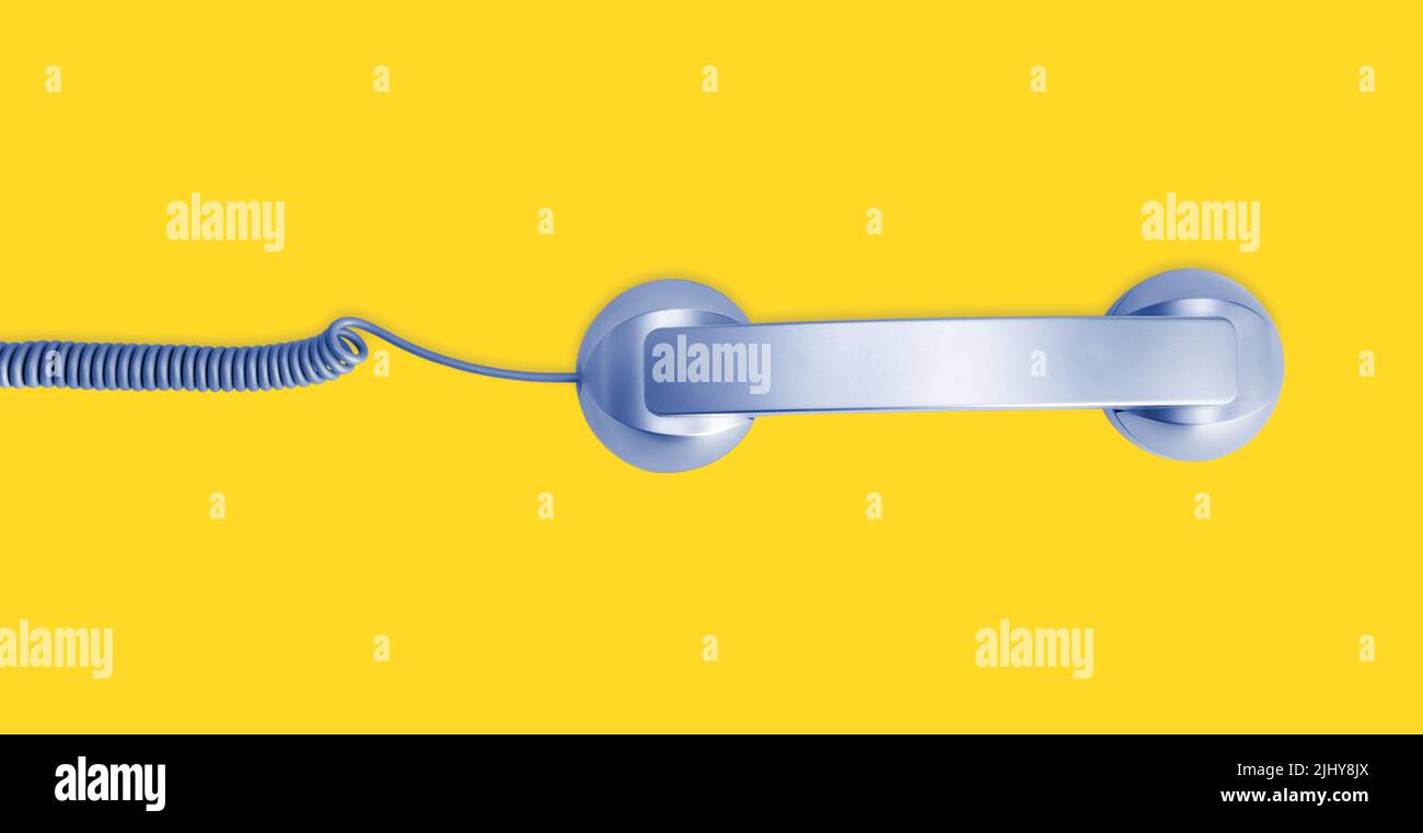 Telephone handset isolated on yellow background. Contact us banner. Top view Stock Photo