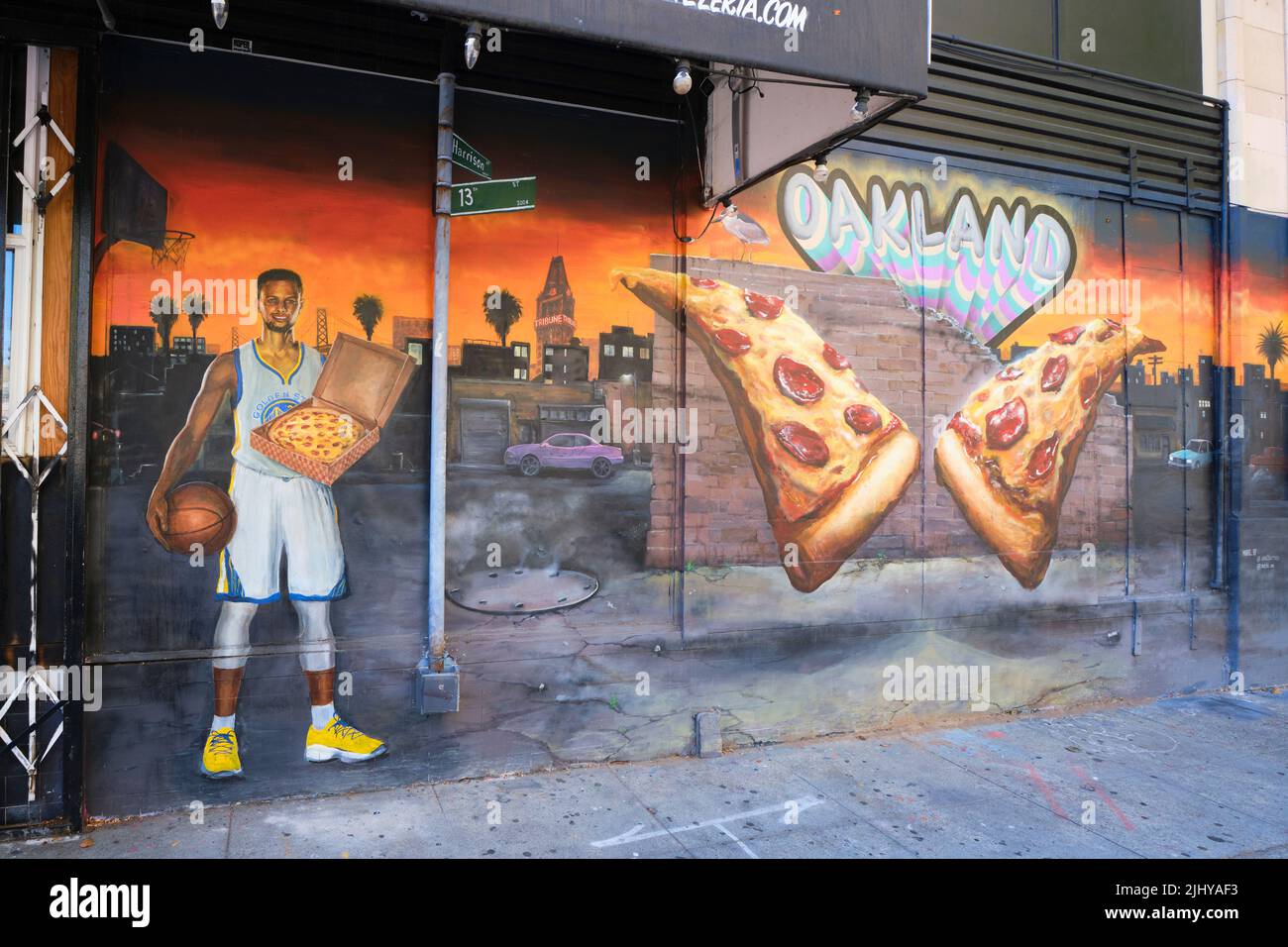 A mural of NBA basketball Golden State Warriors player Stephen Curry holding a pizza box. In the Chinatown section of downtown Oakland, California. Stock Photo