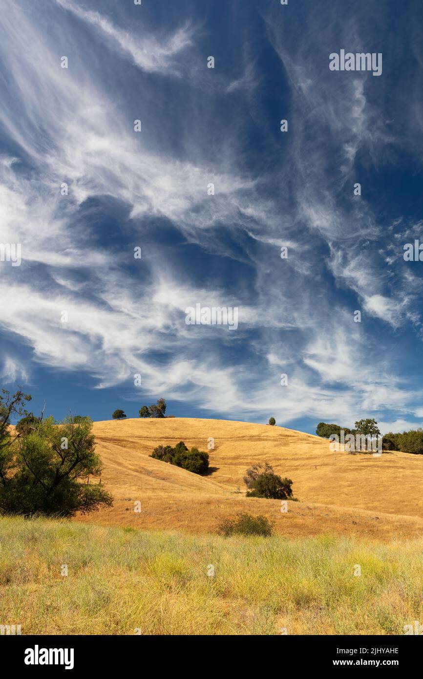 Dramatic wispy clouds over the golden hills near Sutter Creek, California Stock Photo