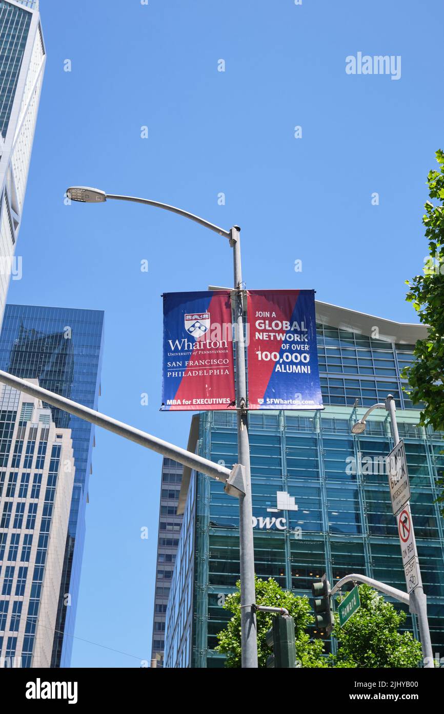 Light pole banners, signs advertisements for the Wharton school MBA study, degree program. In the Mission area of San Francisco, California. Stock Photo