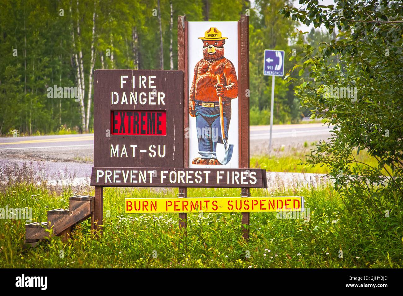 2022 06 26  Mat-Su Alaska USA - Smokey Bear - Prevent Forest Fires sign beside Alaskan highway - Extreme Level - Burn Permits Suspended - wooden steps Stock Photo