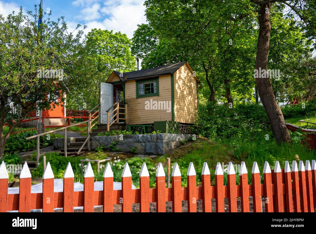 small wooden garden house behind a red garden fence in Sweden Stock ...