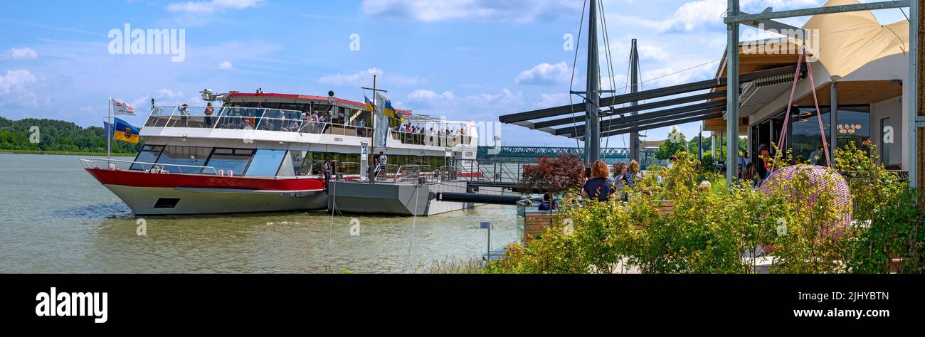 excursion ship of the DDSG Blue Danube company on a jetty aside a restaurant at the river Danube, Austria Stock Photo