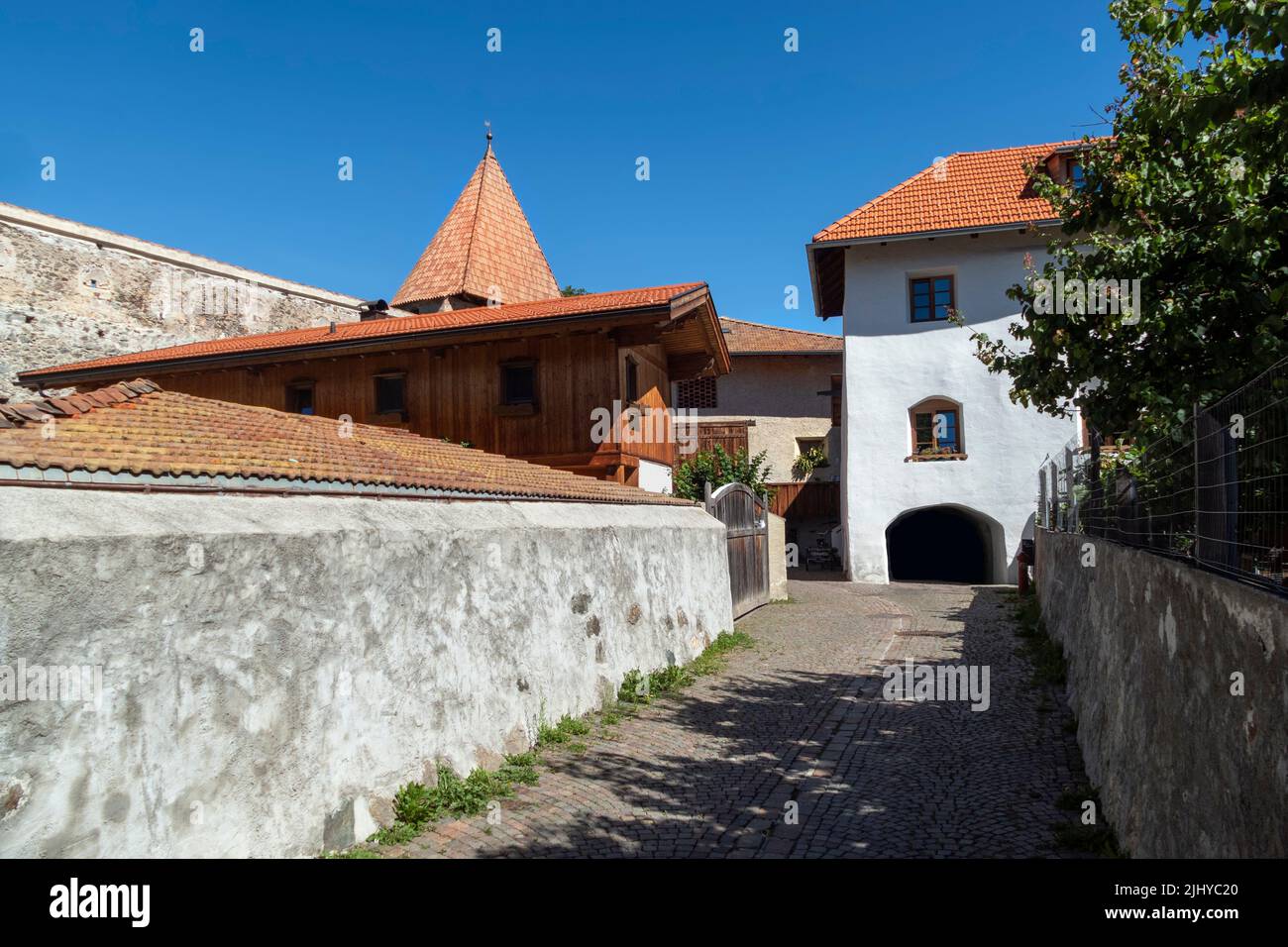 Historic houses with city walls in the background, Glurns/Glorenza, a medieval town, Trentino-Alto Adige, South Tyrol, Italy. Stock Photo