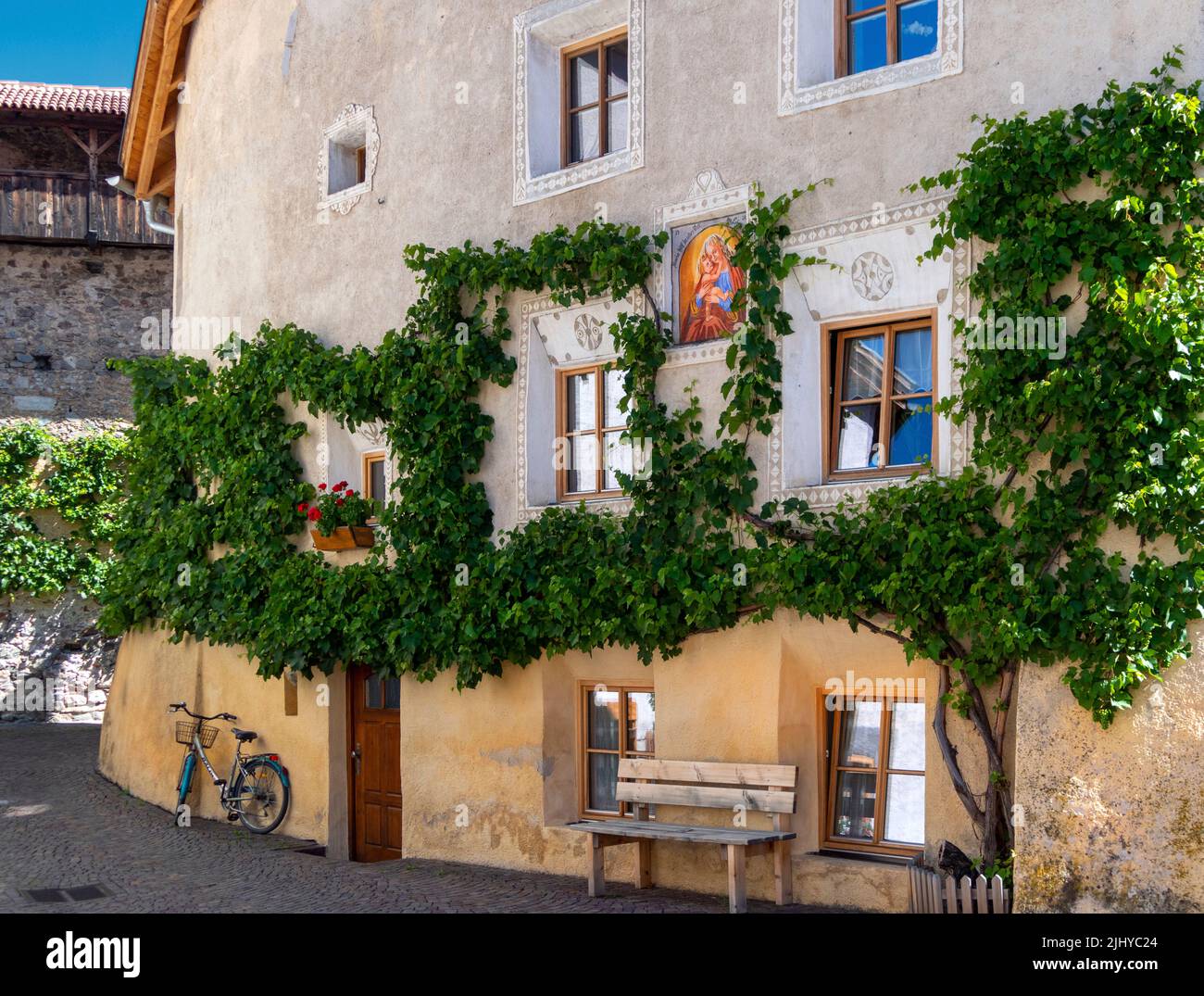 Historic house with painted fresco of Madonna and Child in Glurns/ Glorenza, a medieval town, Trentino-Alto Adige, South Tyrol, Italy. Stock Photo