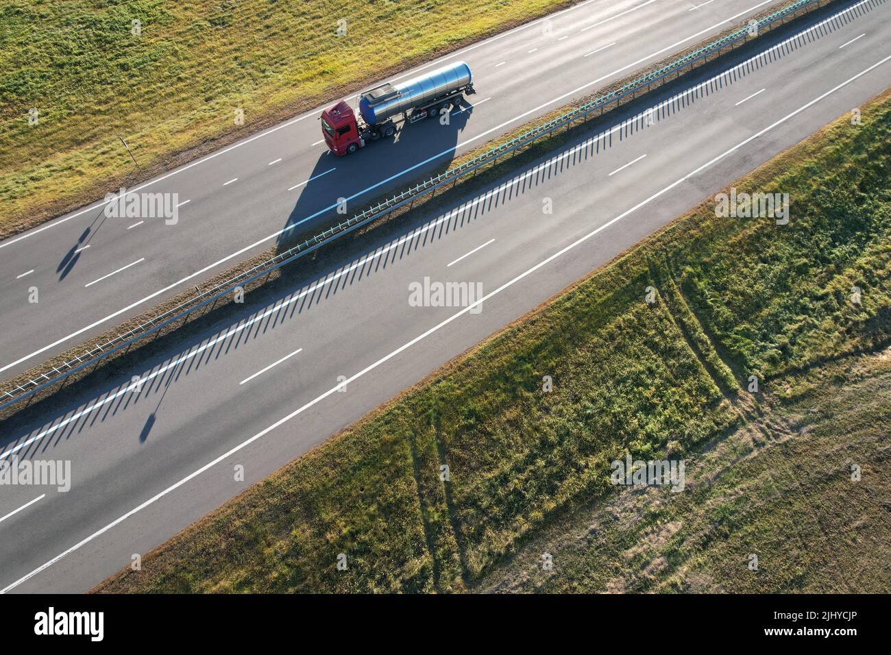 Lorry carry metal cistern on empty highway aerial above view Stock Photo