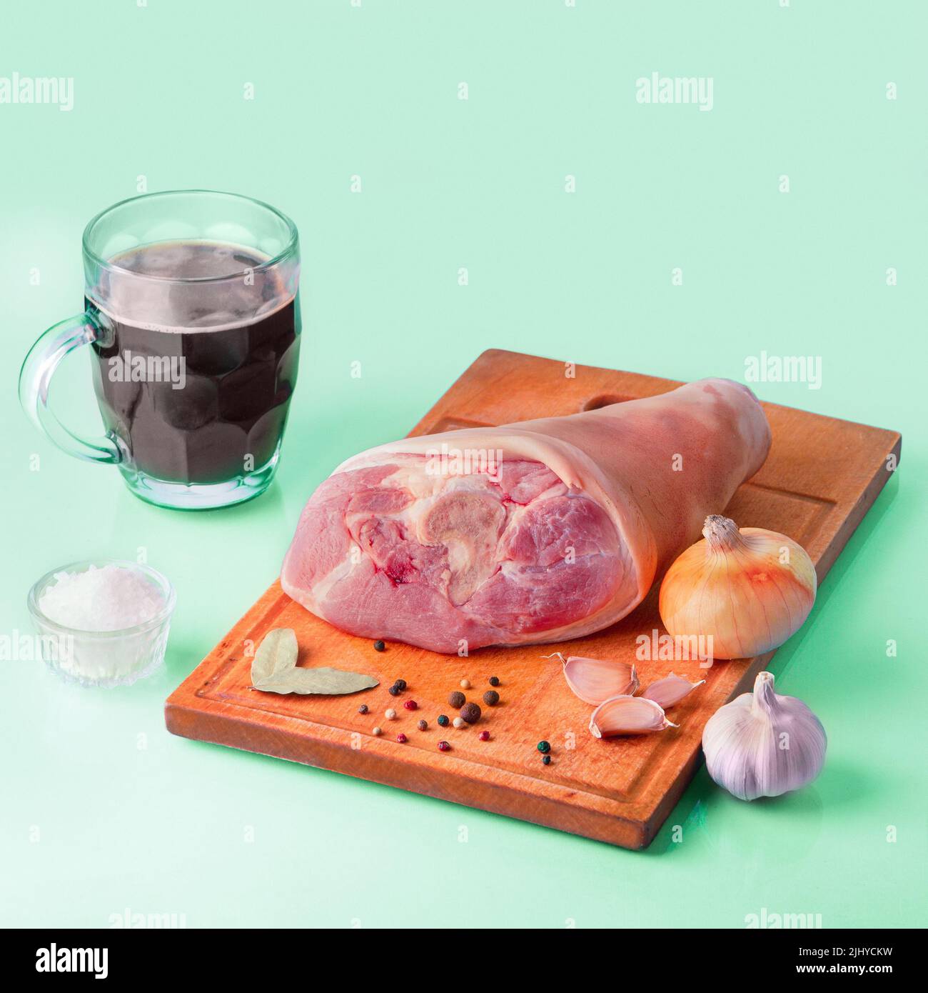 Raw Pork knuckle, stout and other ingredients for cooking baked pork