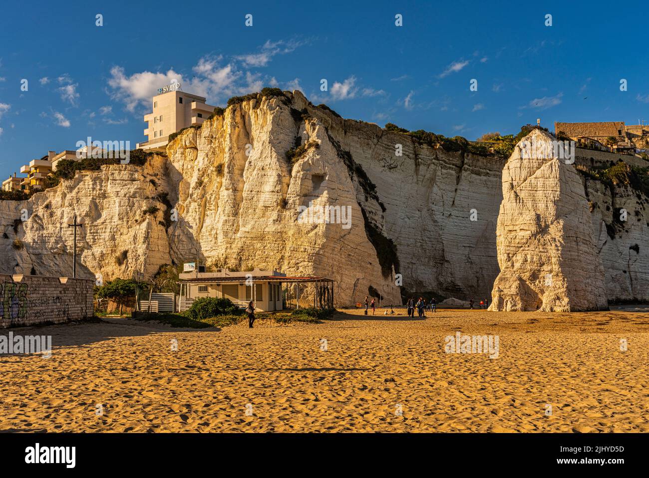 The sandy beach of Pizzomunno with the famous stack in Vieste. Province of Foggia, Apulia, Italy, Europe Stock Photo