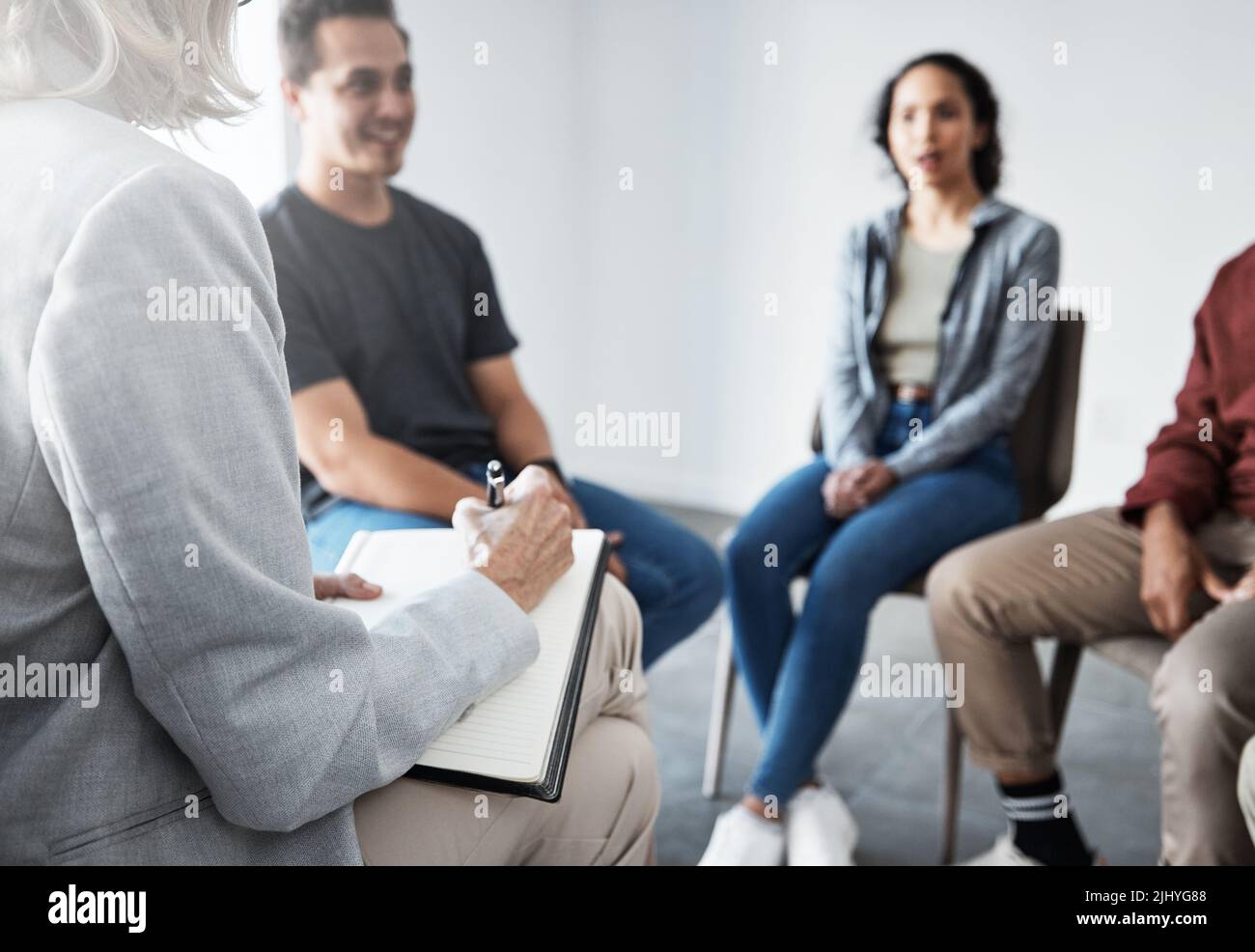 Group therapy. Therapist talking to patients together. Group of people in therapy. Diverse