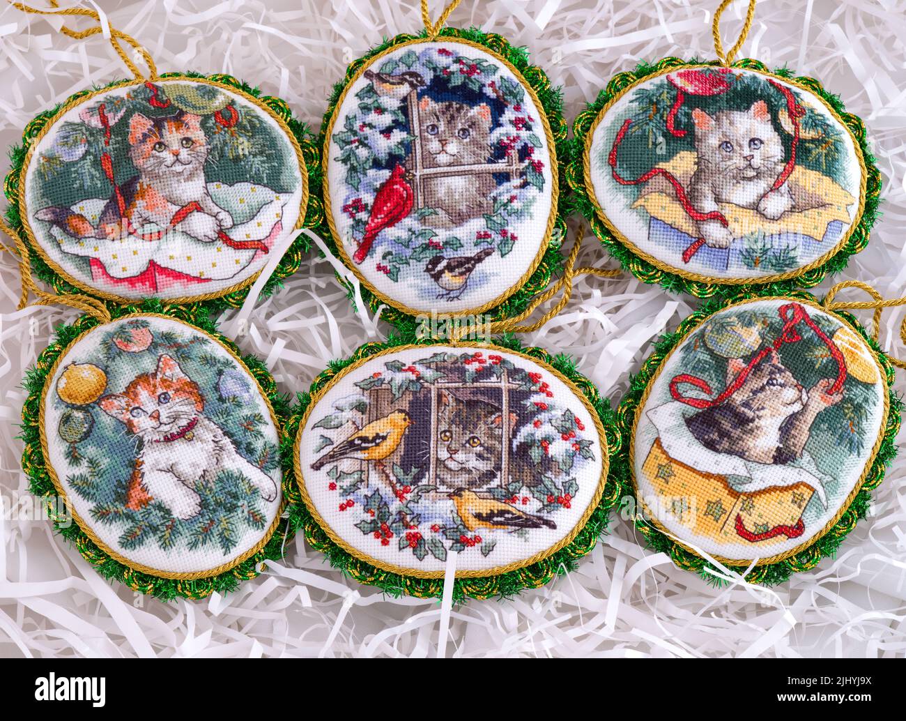 Set of six cross stitched handmade Christmas Tree ornaments. This set is embroidered and made by myself following the design of a Dimensions Kitty Kee Stock Photo