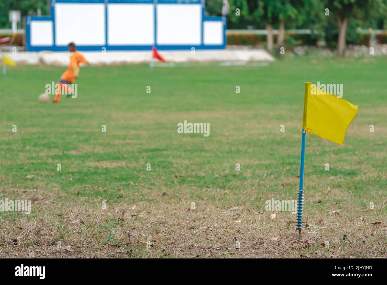 A simple yellow flag on the corner of football field in school. Place
